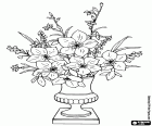 A large bouquet of varied flowers in a decorative vase