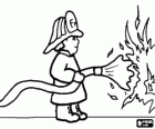 Fireman or firefighter in action with the fire hose extinguishing a fire
