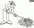 Picking up fallen leaves with a rake, a typical picture of autumn or fall