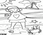 Girl playing on the beach with a crab and a boat sailing on the sea