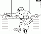 Santa Claus putting gifts in the socks hanging from fireplace