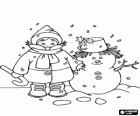 Child with scarf, wool hat and a cane with a snowman decorated with holly leaves