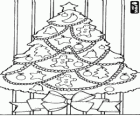 Christmas tree with many decorations and a large bow
