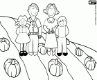A family in the field during the fall with the harvest of pumpkins
