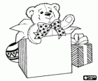 Christmas gift boxes with a teddy bear peeking out from one of them and a ball