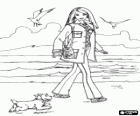 Barbie walking along the beach with his dog