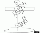 Cross stuck in the ground adorned with a garland of flowers