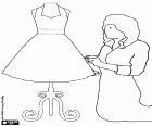 Dressmaker or seamstress working on a dress with the mannequin