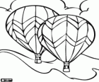 A couple of balloons flying over the mountains