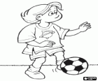 Young soccer player practicing with the ball