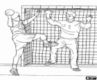 In a game of handball the player throwing the ball with the goalkeeper in the goal box