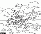 Girl riding a bicycle in the park in spring