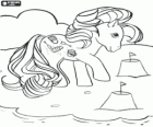 My little pony on the beach playing with sand castles
