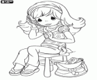 Young girl from Precious Moments sitting on a stool while talking on the cell phone