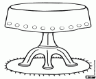 Small round table with a tablecloth and on a carpet
