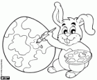 Painter rabbit decorates an easter egg