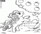 A little pony trying to eat an apple from the tree