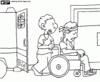 A hospital orderly is helping a patient to move in a wheelchair by the hospital