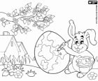 All ready for the arrival of Easter, a rabbit paints an Easter egg