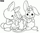 Two bunnies with a large carrot in a scene from Precious Moments