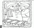 Teo in the mountains in winter with a snowman and a sleigh