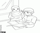 A boy and a girl reading the Quran in Indonesia