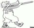 A clown walking while plays a trumpet, seen from side