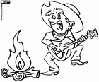 A cowboy singing, dancing and playing the guitar next to the bonfire of the camp during the night