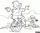 A child riding a unicycle, his dog runs to his side. A unicycle is a vehicle for a single wheel with pedals