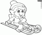The girl has fun with sleigh on the snow