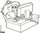 A girl in the school computer class. The girl is sitting at the table with a computer
