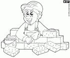 A builder or a bricklayer is working on the construction of a brick wall