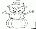 A monster made with three Halloween pumpkins, a hat and two branches as arms and hands