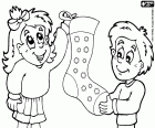 A couple of children with a large Christmas sock for gifts