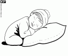 A baby is resting leaning on a large cushion